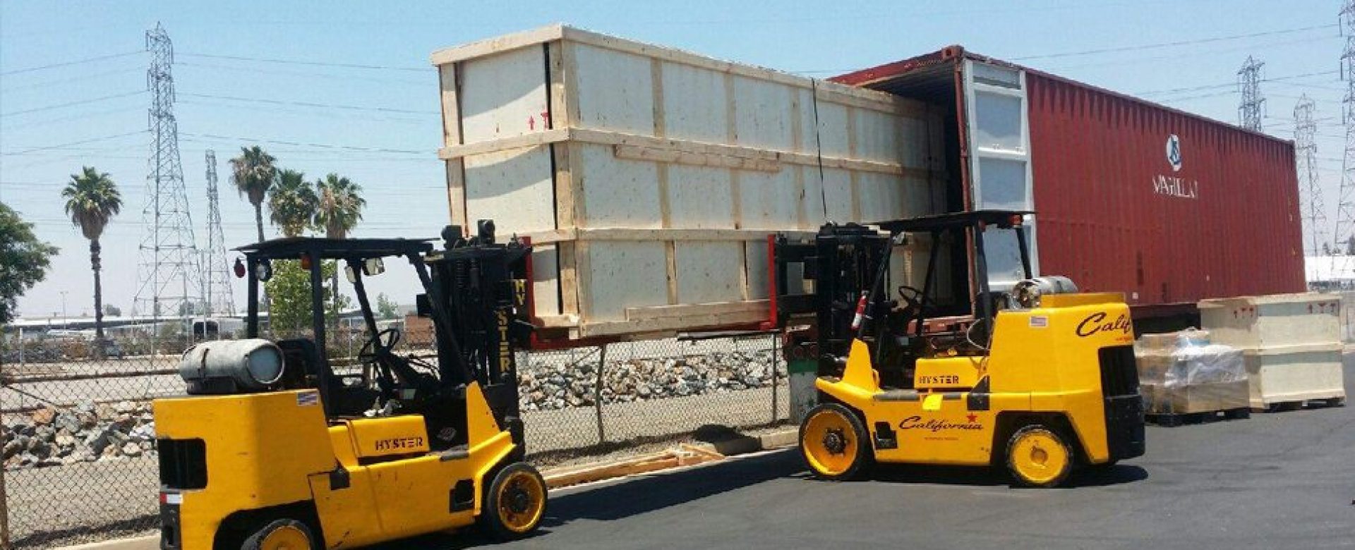 hyster forklift lifting large wooden crate